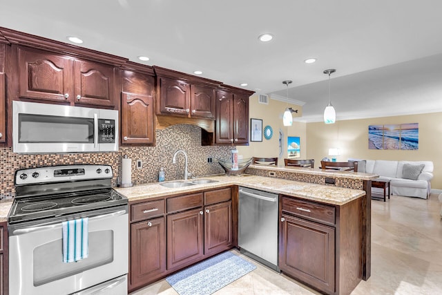 87465 Old Hwy Unit 106, Islamorada, FL 33036 - kitchen with stainless steel appliances, ornamental molding, a peninsula, backsplash, and decorative light fixtures