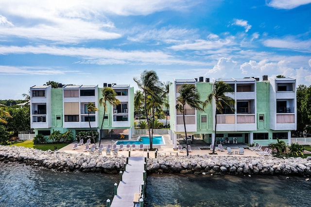 87465 Old Hwy Unit 106, Islamorada, FL 33036 - dock area featuring a patio, a water view, and a community pool