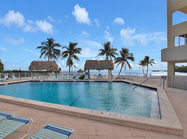 view of swimming pool with a gazebo, a water view, and a patio