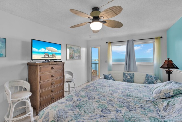 bedroom with ceiling fan and a textured ceiling