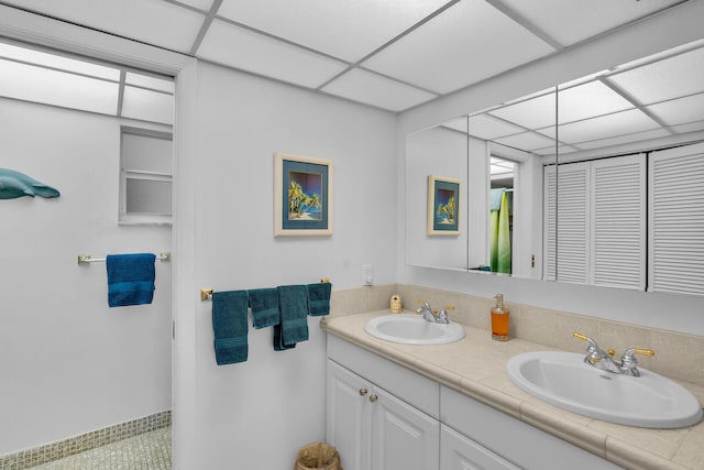 bathroom with vanity and a paneled ceiling