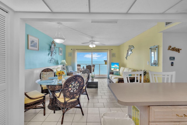 tiled dining room featuring ceiling fan