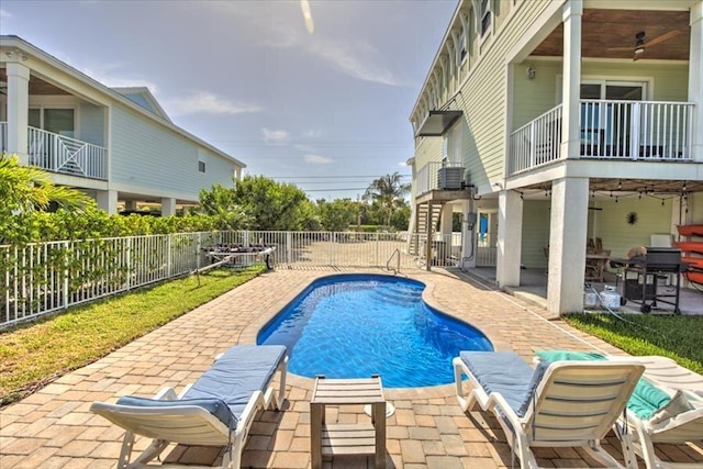 view of swimming pool featuring ceiling fan and a patio area