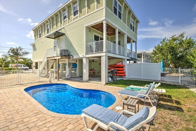 view of pool with a patio and ceiling fan