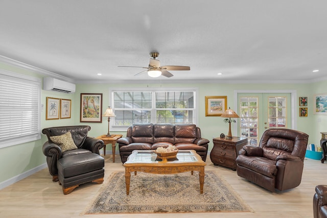 living room with french doors, crown molding, light hardwood / wood-style flooring, and an AC wall unit