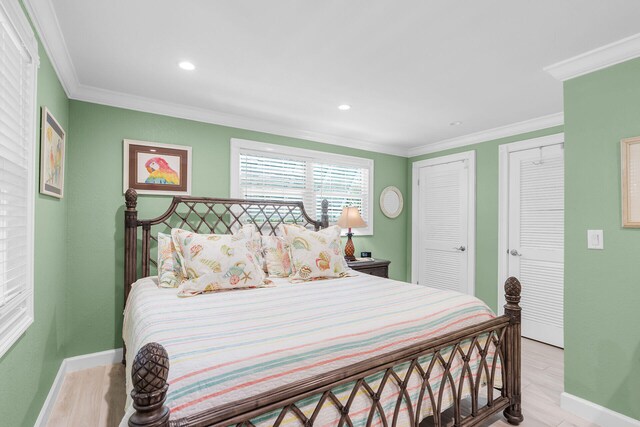 285 Blackbeard Rd, Little Torch, FL 33042 - bedroom featuring multiple closets, ornamental molding, and light hardwood / wood-style floors