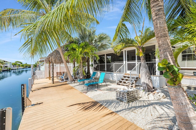 dock area with a patio and a water view