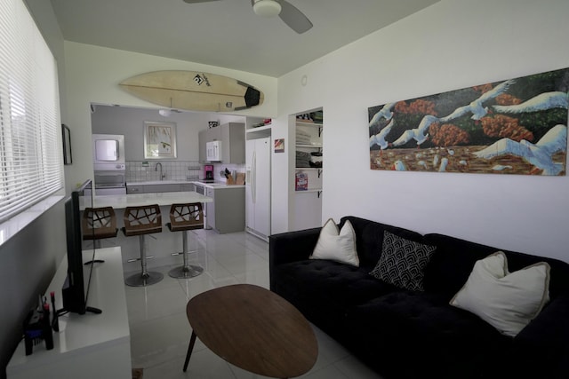 tiled living room featuring sink and ceiling fan