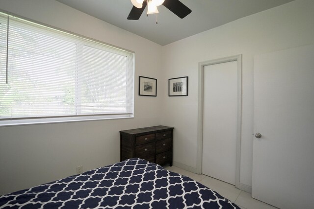 bedroom with ceiling fan and light tile patterned floors