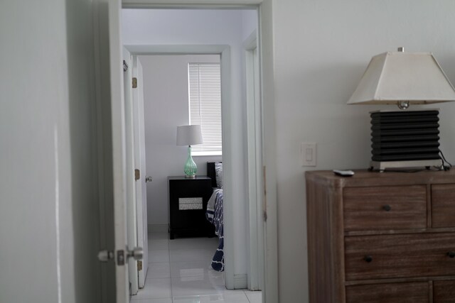 hall with light tile patterned floors