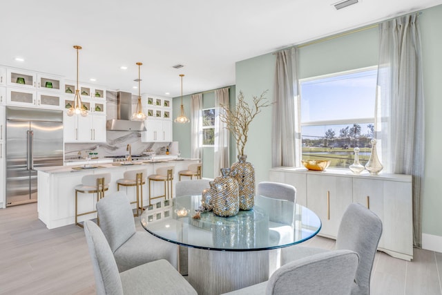 dining area with a wealth of natural light and light hardwood / wood-style floors