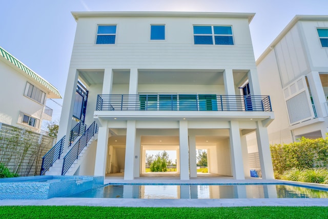 rear view of house featuring a balcony