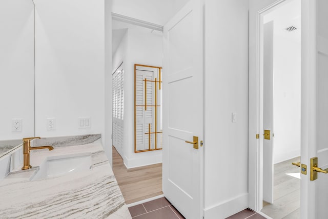 bathroom with tile patterned flooring and vanity