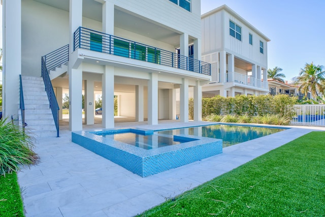 view of swimming pool featuring an in ground hot tub and a patio area