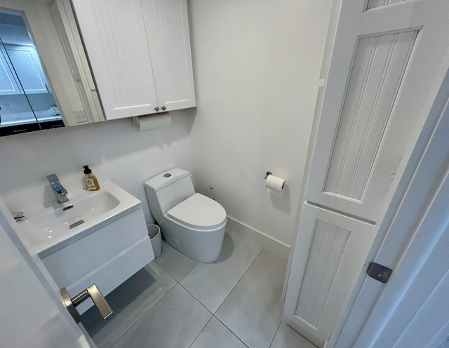 bathroom featuring vanity, toilet, and tile patterned flooring