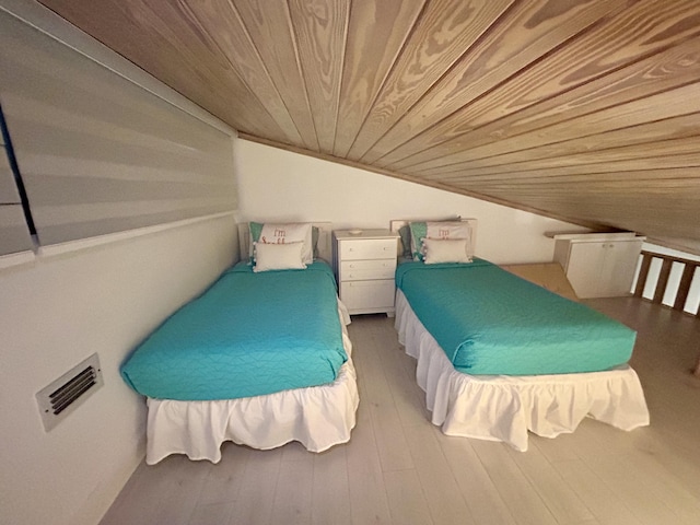 bedroom featuring wood ceiling, lofted ceiling, and hardwood / wood-style floors