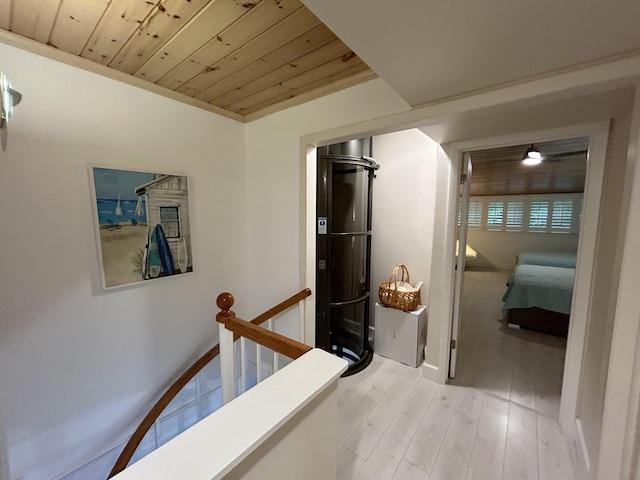 hall with wood ceiling and light hardwood / wood-style flooring