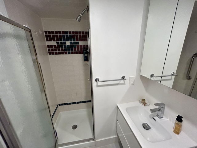 bathroom featuring sink and a shower with shower door