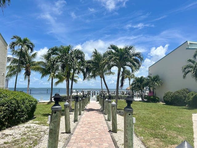 view of property's community featuring a water view and a lawn