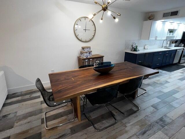 dining area featuring sink and light wood-type flooring