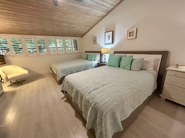 bedroom with vaulted ceiling, wooden ceiling, and light hardwood / wood-style floors