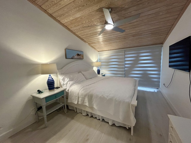 bedroom with lofted ceiling, ceiling fan, ornamental molding, wooden ceiling, and light wood-type flooring