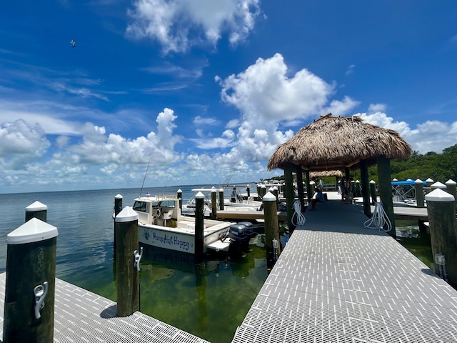 view of dock featuring a gazebo and a water view