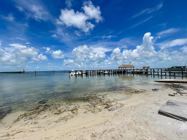 dock area with a view of the beach and a water view