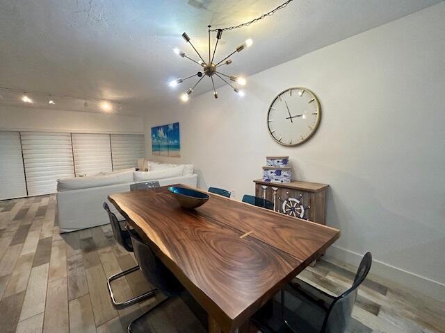 dining area featuring light hardwood / wood-style floors and a notable chandelier