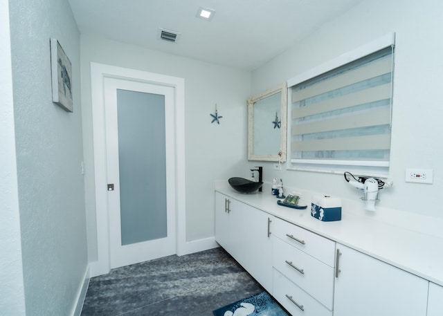 25 N Blackwater Ln, Key Largo, FL 33037 - bathroom featuring baseboards and vanity