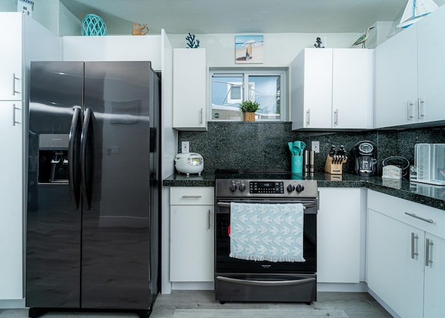 25 N Blackwater Ln, Key Largo, FL 33037 - kitchen featuring black fridge with ice dispenser, stainless steel electric range, backsplash, white cabinets, and light wood finished floors