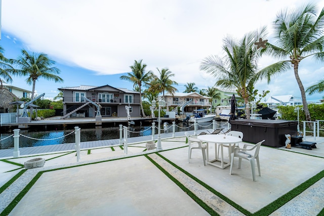 25 N Blackwater Ln, Key Largo, FL 33037 - view of patio / terrace featuring a hot tub, a water view, and a boat dock