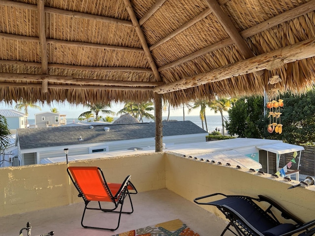 view of patio with a gazebo and a water view