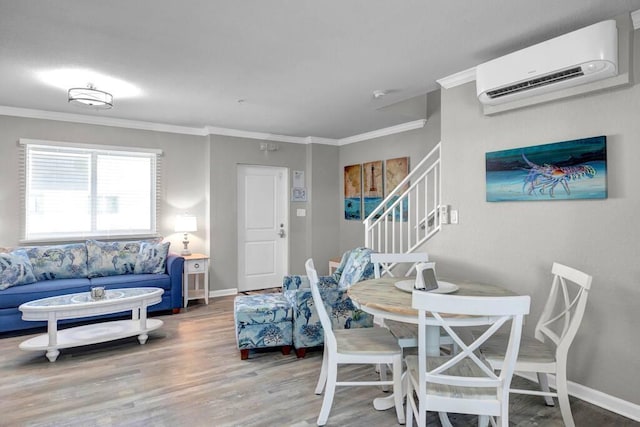 dining area featuring hardwood / wood-style floors, crown molding, and a wall unit AC