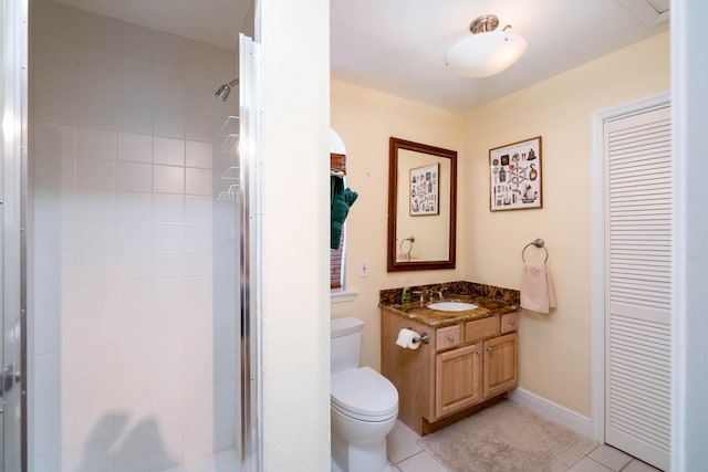 bathroom with vanity, tile patterned floors, a shower with door, and toilet