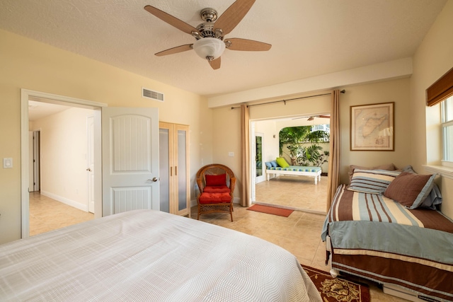 bedroom with light tile patterned flooring, ceiling fan, a textured ceiling, and access to outside