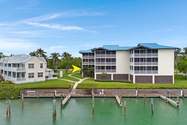 back of house featuring a water view and a yard