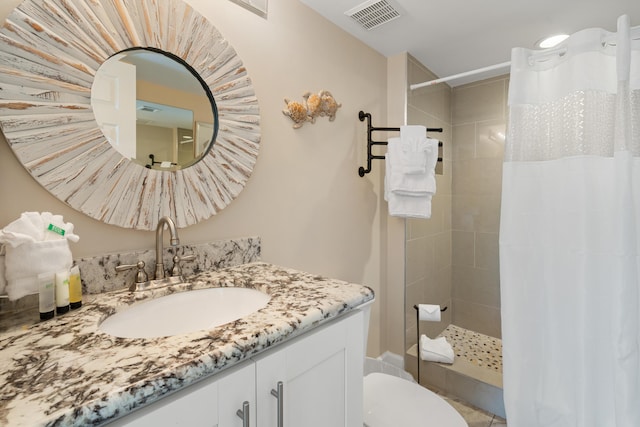 bathroom featuring walk in shower, vanity, and toilet