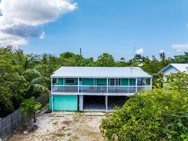 back of house featuring a carport