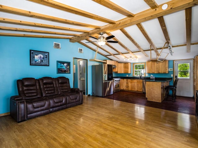 living room featuring sink, dark wood-type flooring, vaulted ceiling with beams, and ceiling fan