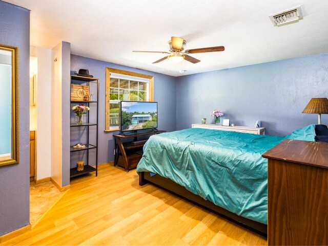 bedroom with hardwood / wood-style flooring and ceiling fan