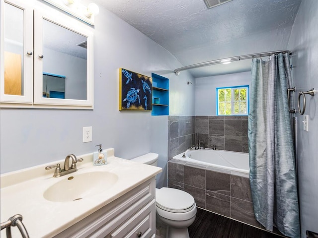 full bathroom with hardwood / wood-style floors, vanity, a textured ceiling, toilet, and shower / bath combo with shower curtain