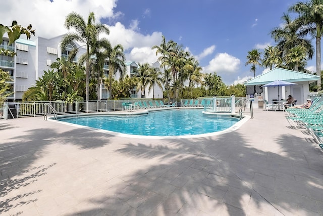 pool featuring a patio area and fence