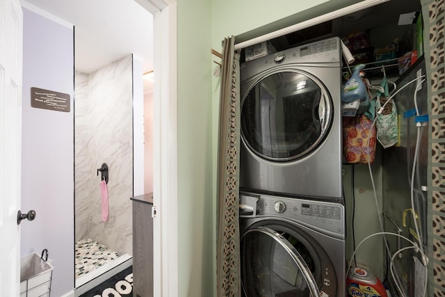 washroom featuring stacked washer / dryer