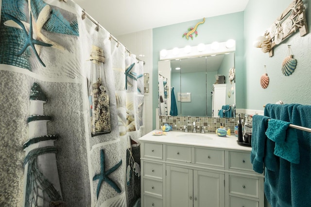 bathroom featuring tasteful backsplash and vanity