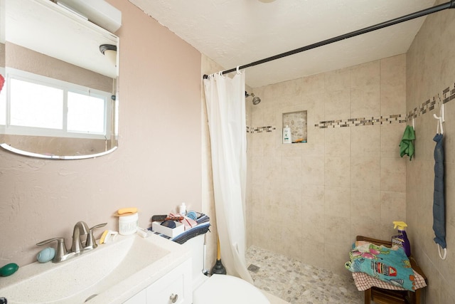 bathroom with vanity, toilet, and walk in shower