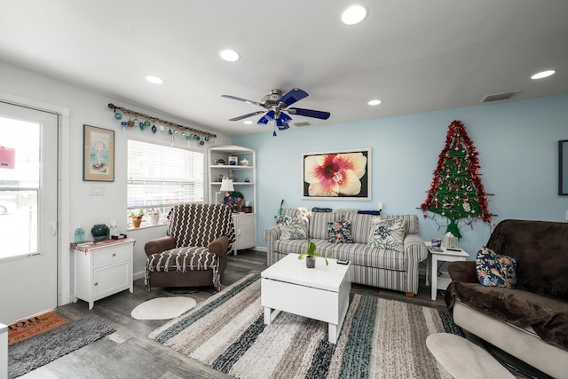 living room with dark wood-type flooring and ceiling fan