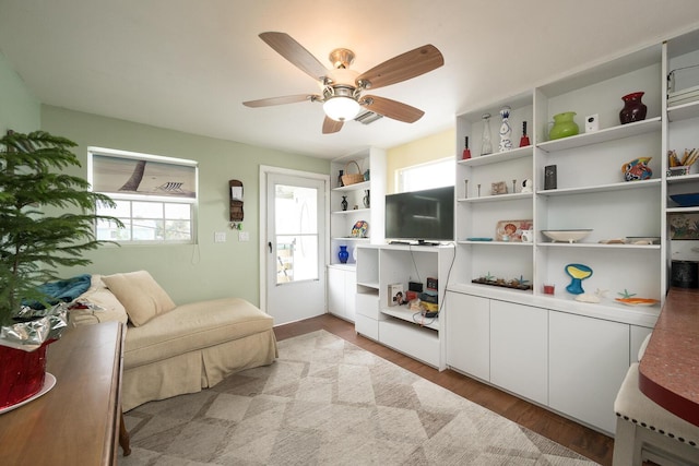 sitting room with ceiling fan and light hardwood / wood-style flooring