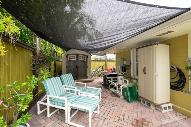 view of patio with a storage shed