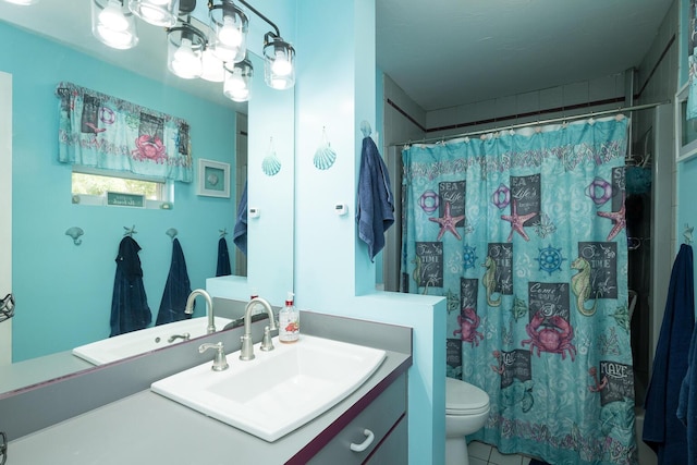 bathroom with vanity, toilet, and a shower with shower curtain